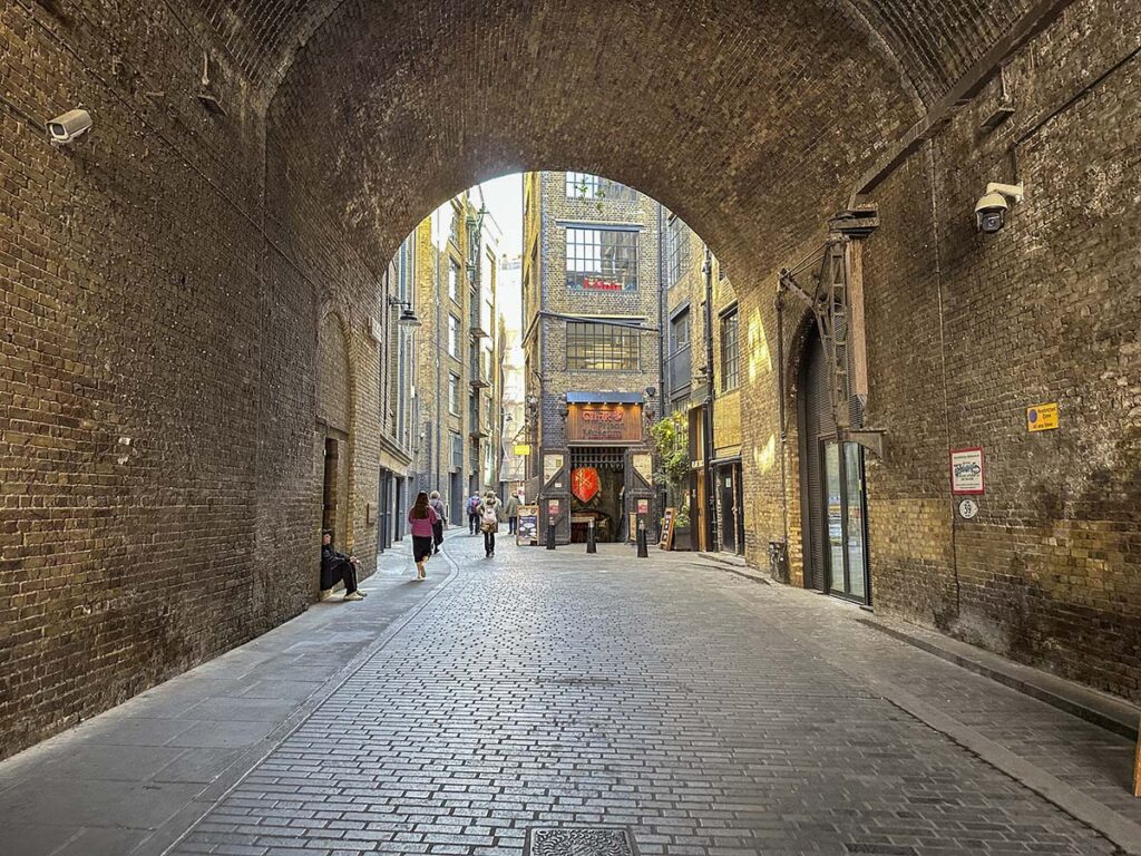 Walking through a tunnel with cobblestone streets in central London