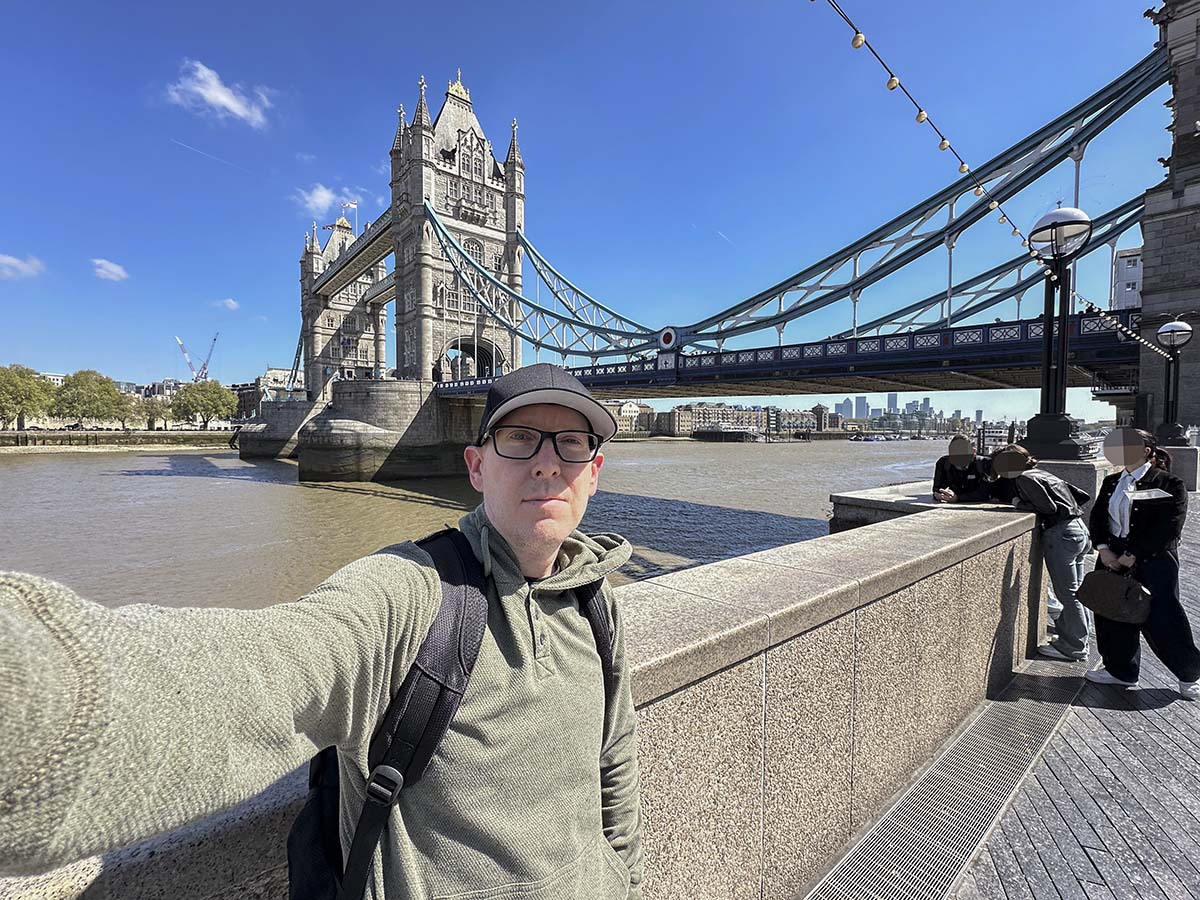 Scott Leazenby standing next to the London Tower Bridge