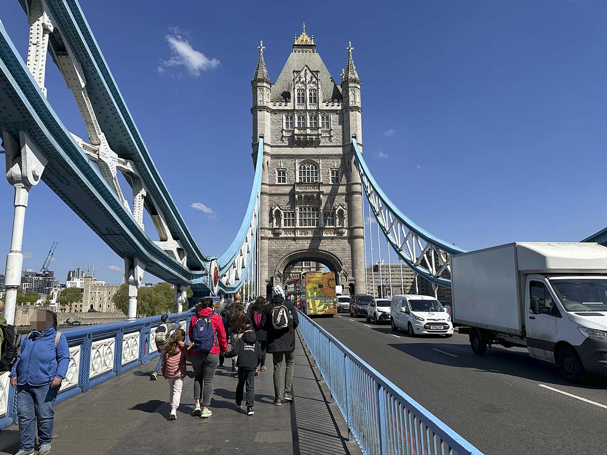 Pedestrians walking across the London Tower Bridge